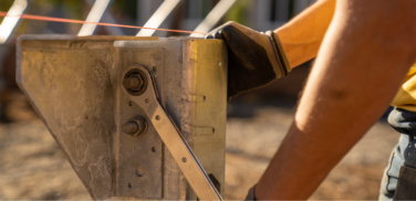 Close up of a worker tightening in a section of a Ground Frame solution.